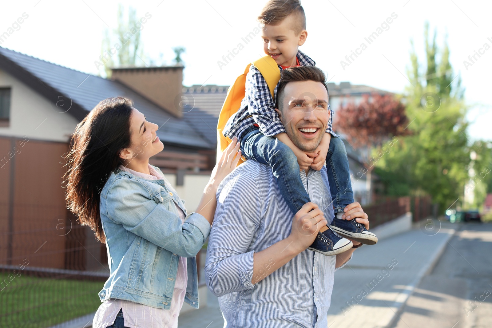 Photo of Young woman taking their little child to school