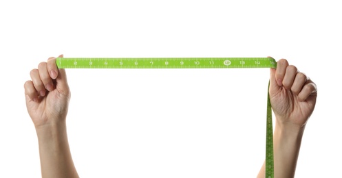 Photo of Woman holding green measuring tape on white background, closeup