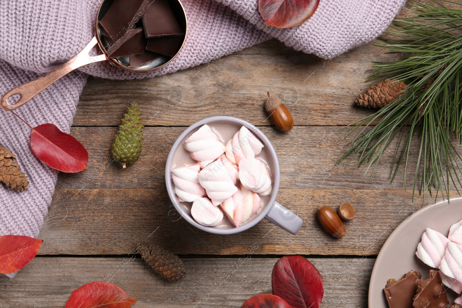 Photo of Flat lay composition with hot cozy drink and autumn leaves on wooden background