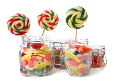 Photo of Jars with tasty jelly candies and lollipops on white background