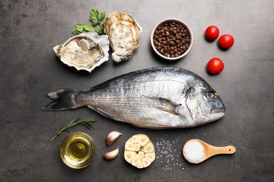 Photo of Flat lay composition with fresh raw dorado fish, oysters and spices on grey table