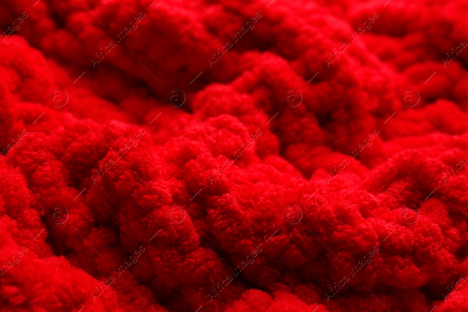 Photo of Soft red knitted fabric as background, closeup