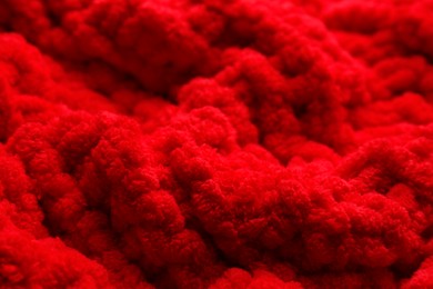 Photo of Soft red knitted fabric as background, closeup