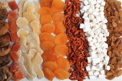 Photo of Different tasty dried fruits as background, top view