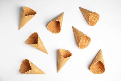 Photo of Waffle empty ice cream cones on white background, top view
