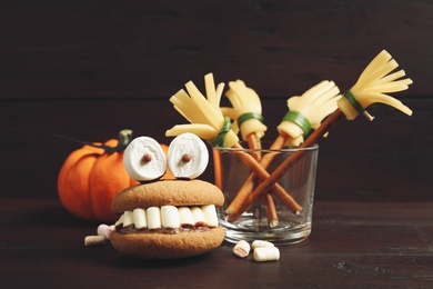 Photo of Delicious Halloween themed dessert on wooden table