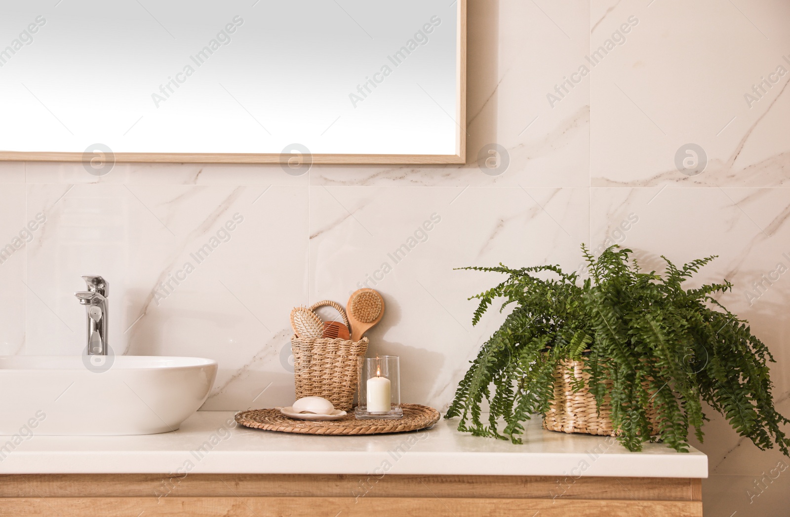 Photo of Stylish bathroom interior with countertop, mirror and houseplant. Design idea