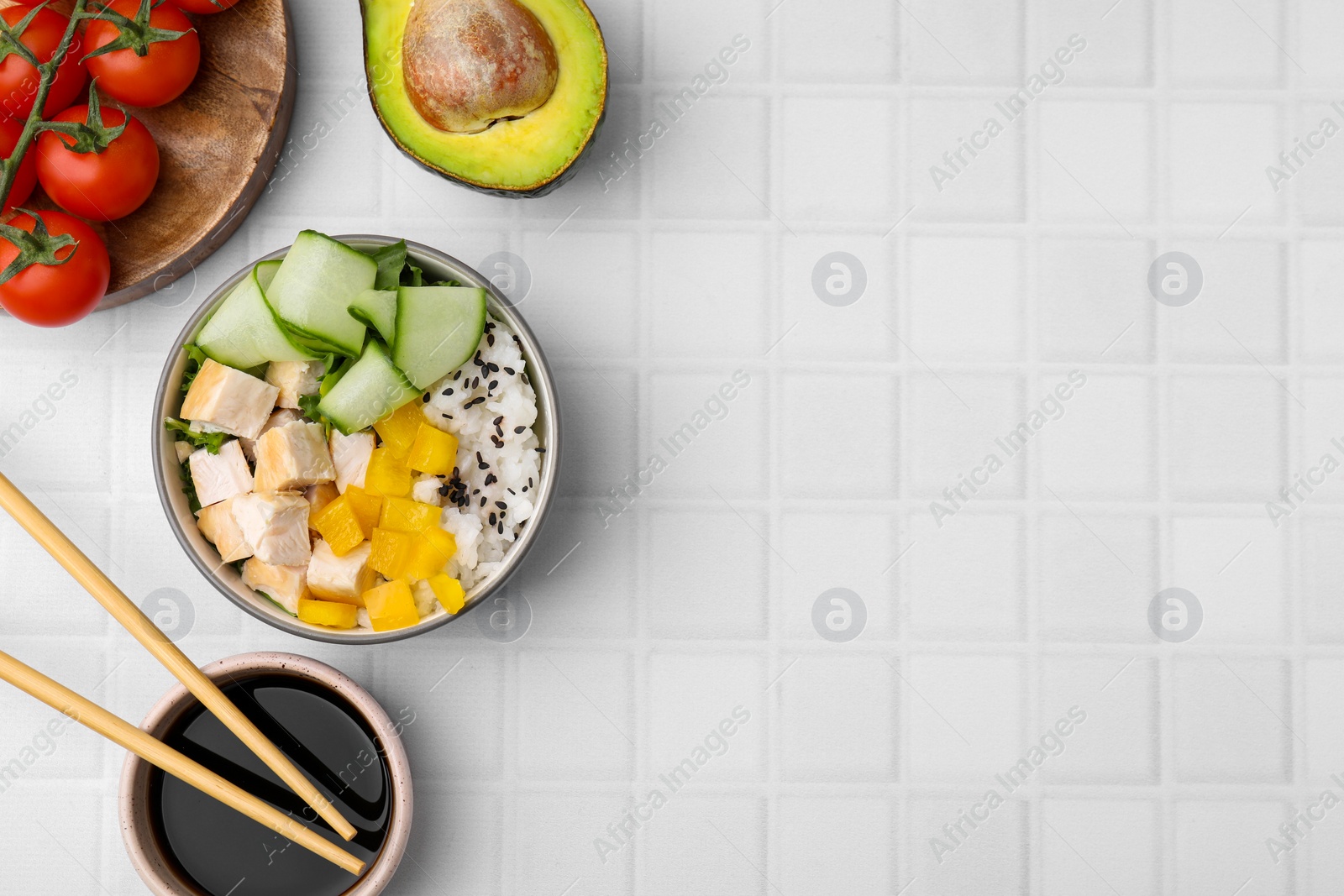 Photo of Delicious poke bowl with meat, rice and vegetables served on white table, flat lay. Space for text