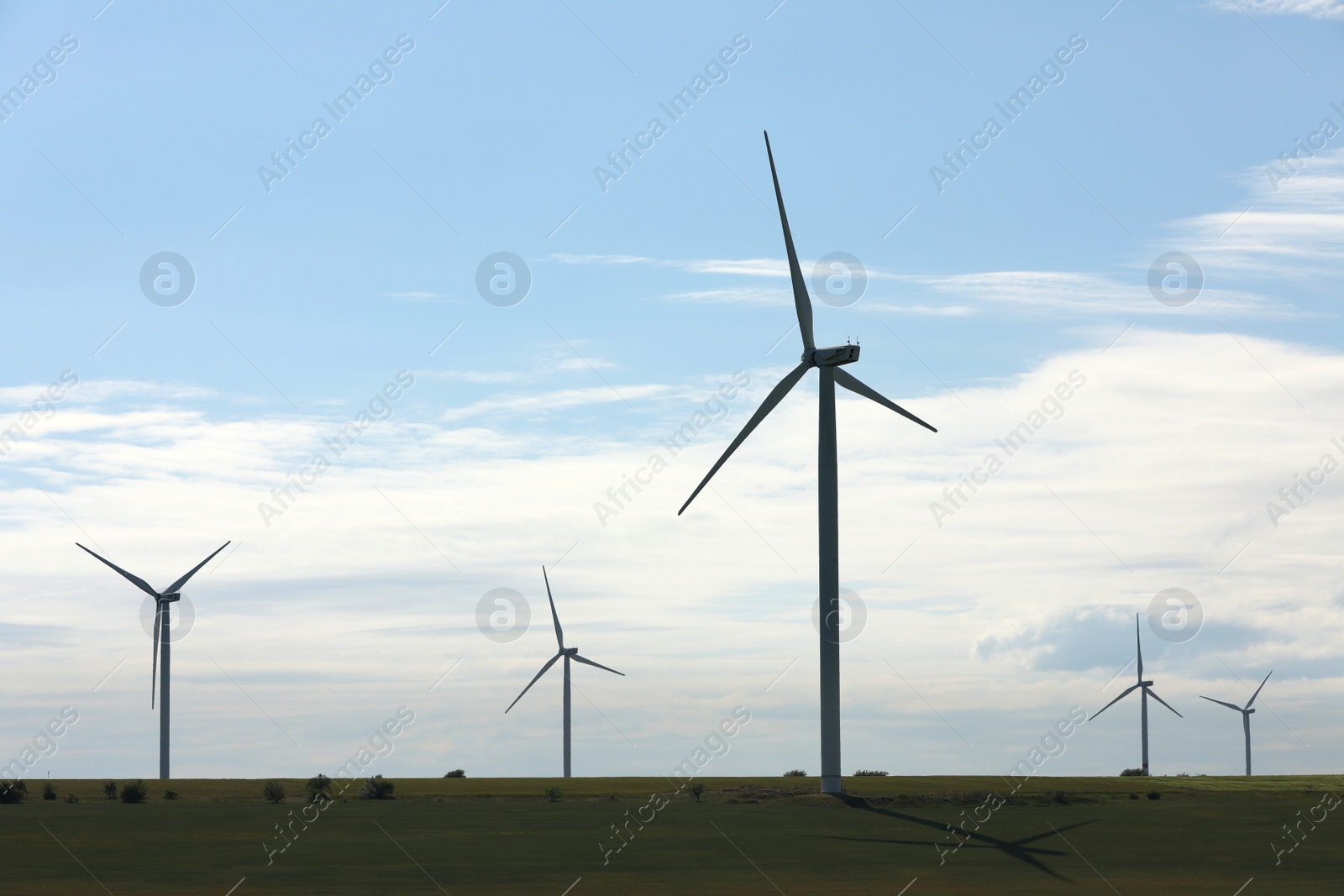 Photo of Beautiful view of field with wind turbines. Alternative energy source