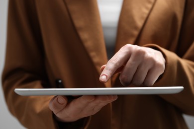 Photo of Closeup view of woman using modern tablet