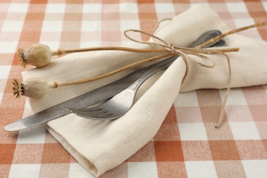 Photo of Stylish setting with cutlery and napkin on table, closeup