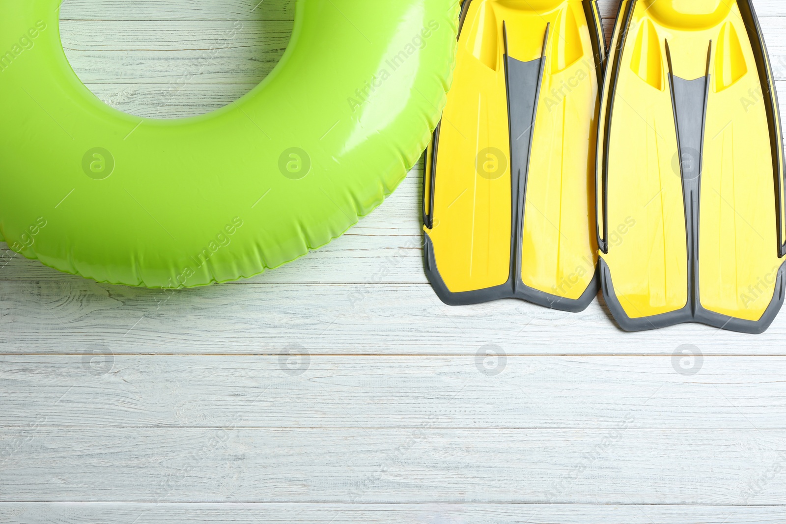 Photo of Flat lay composition with beach accessories on white wooden background, space for text