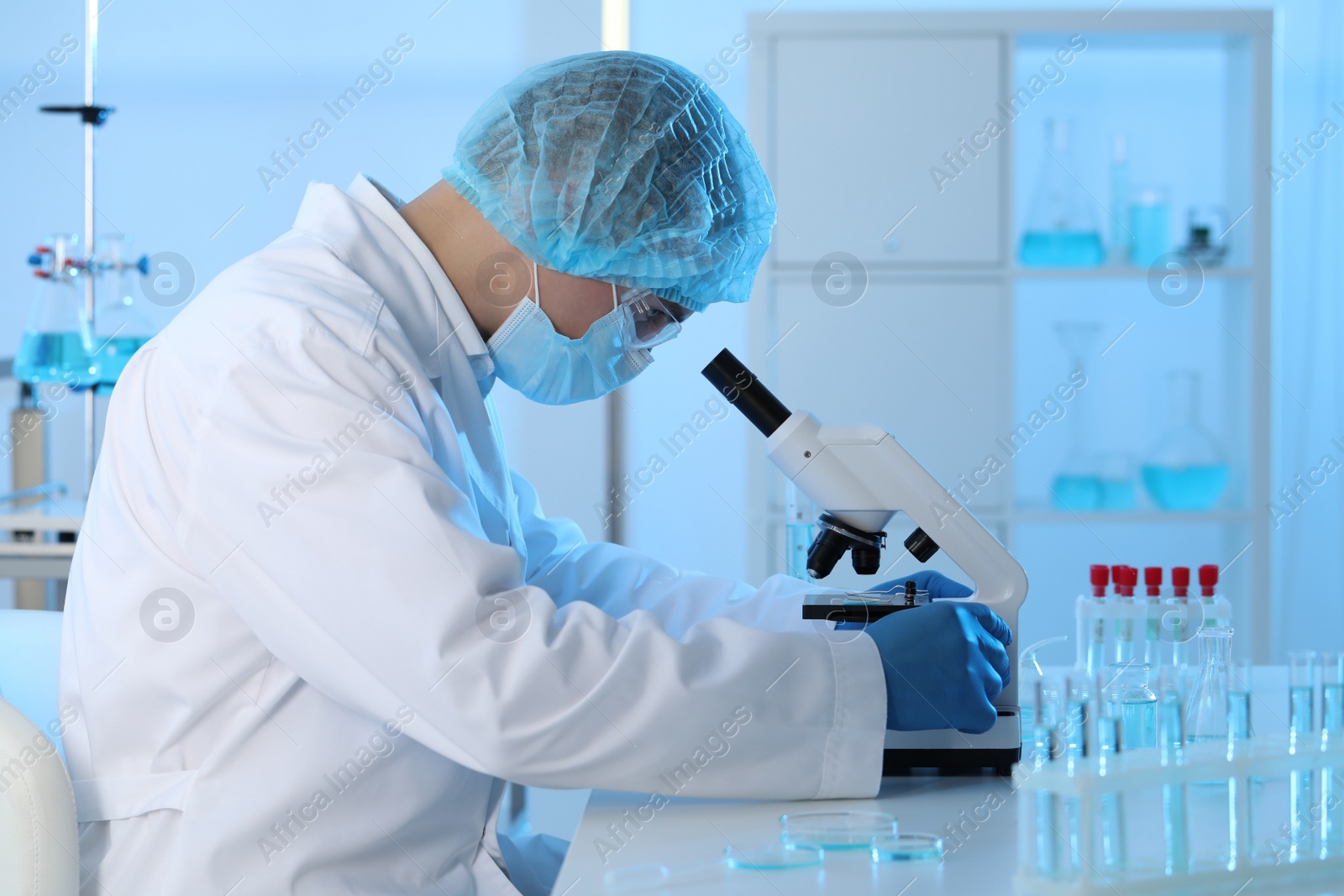 Photo of Scientist working with microscope in laboratory. Medical research