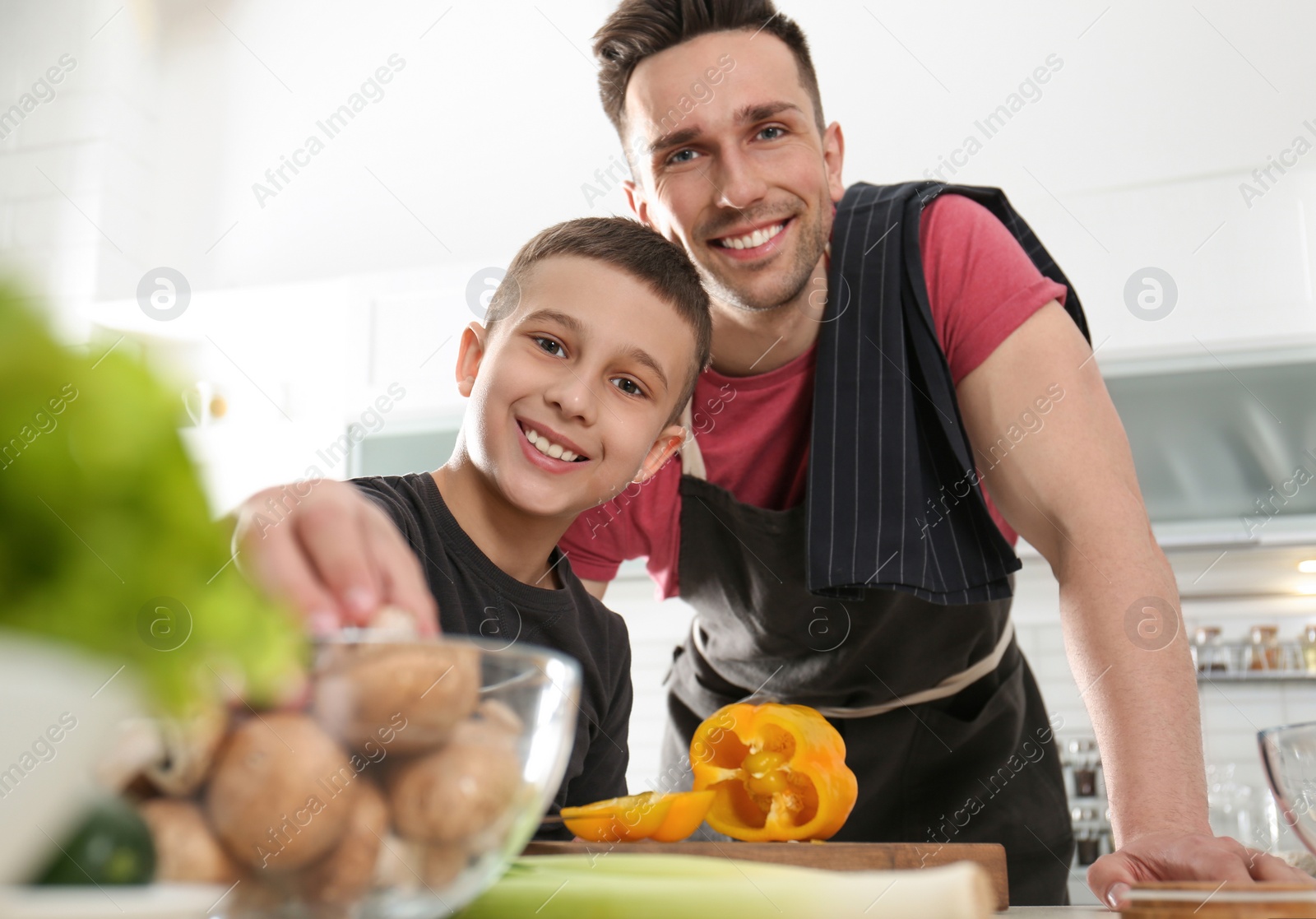 Photo of Dad and son cooking together in kitchen