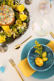 Festive Easter table setting with beautiful floral decor and eggs, above view