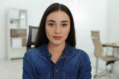 Portrait of beautiful young woman in office