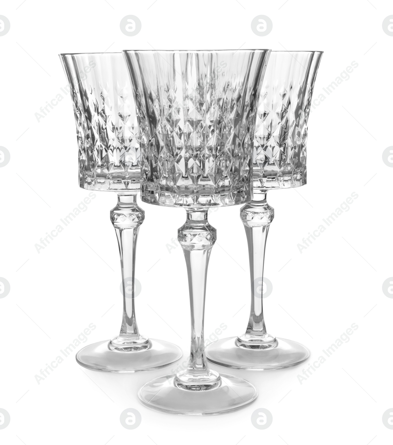 Photo of Elegant clean empty wine goblets isolated on white