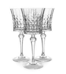 Photo of Elegant clean empty wine goblets isolated on white