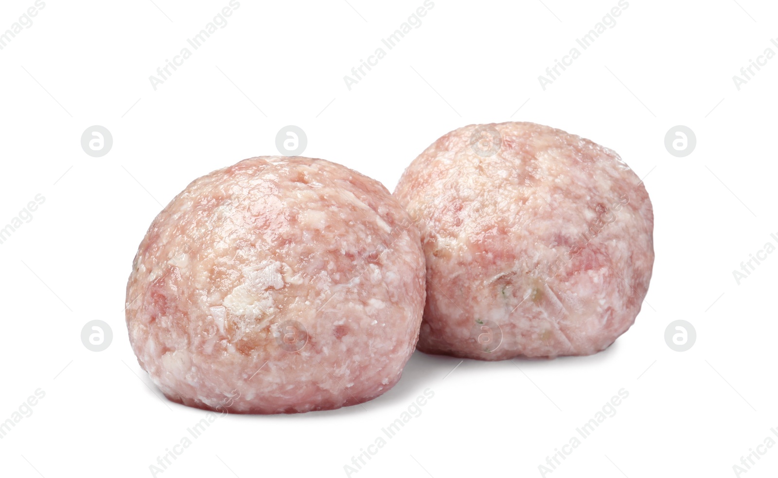 Photo of Two fresh raw meatballs isolated on white