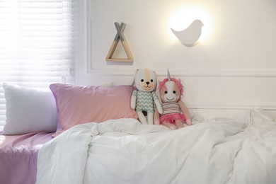 Bird shaped night lamp on wall in child's room