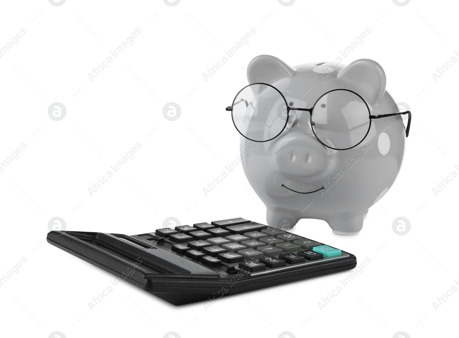 Photo of Calculator and grey piggy bank in glasses isolated on white