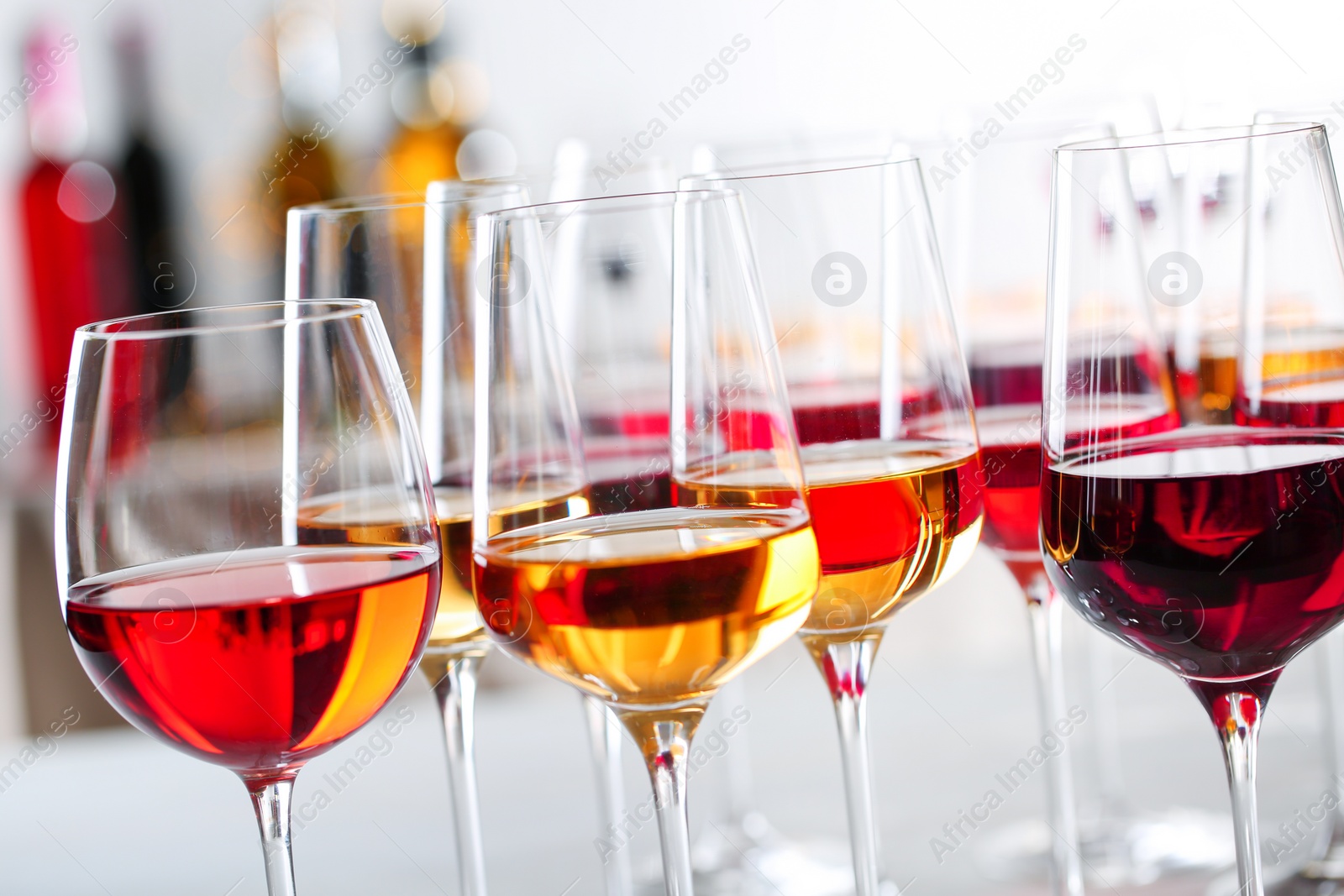 Photo of Glasses with different wines on blurred background, closeup