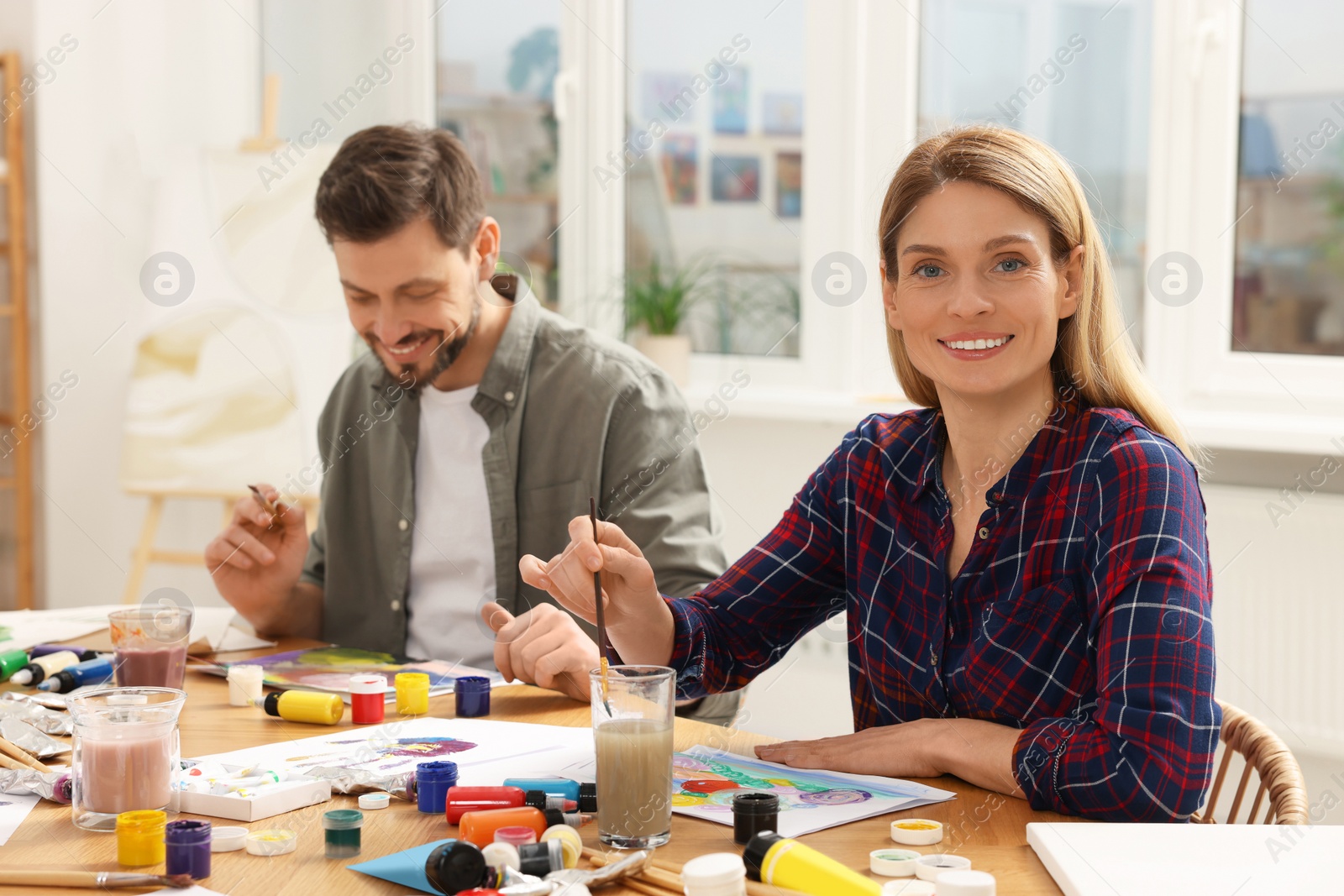 Photo of Students attending painting class in studio. Creative hobby