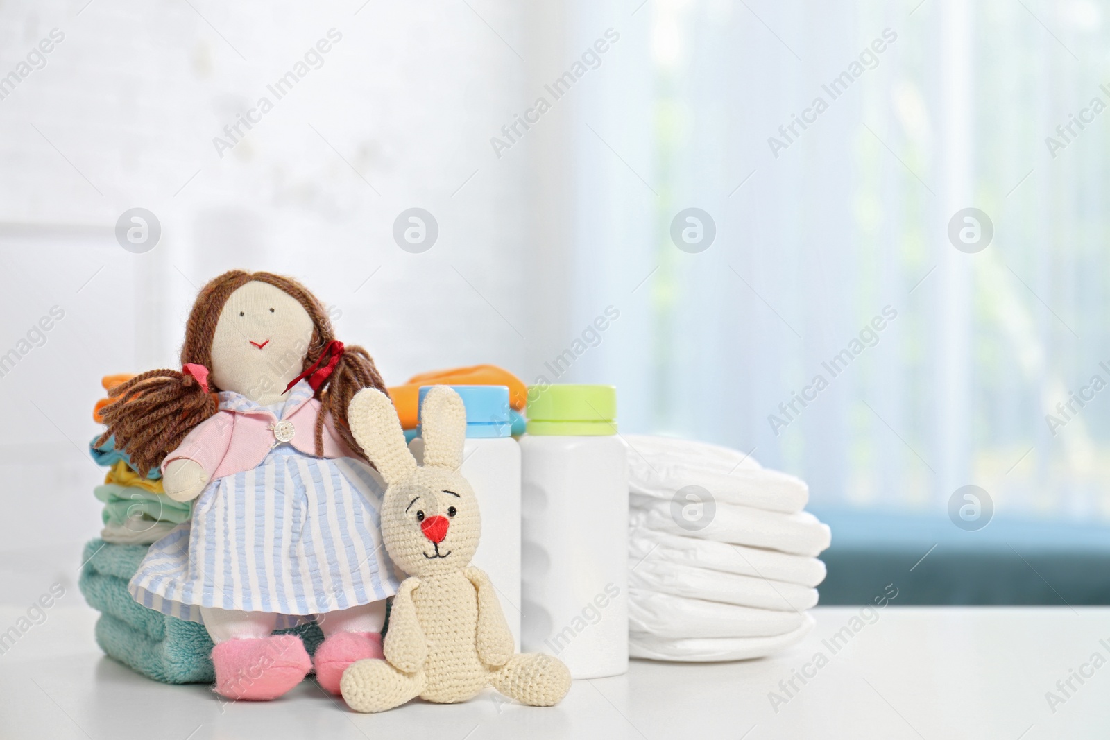 Photo of Baby accessories on table in nursery room. Space for text