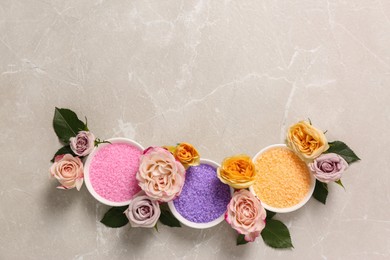 Photo of Bowls with different sea salt and beautiful roses on light marble table, flat lay. Space for text