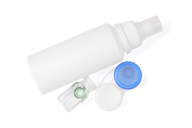 Photo of Color contact lenses and bottles of cosmetic product isolated on white, top view