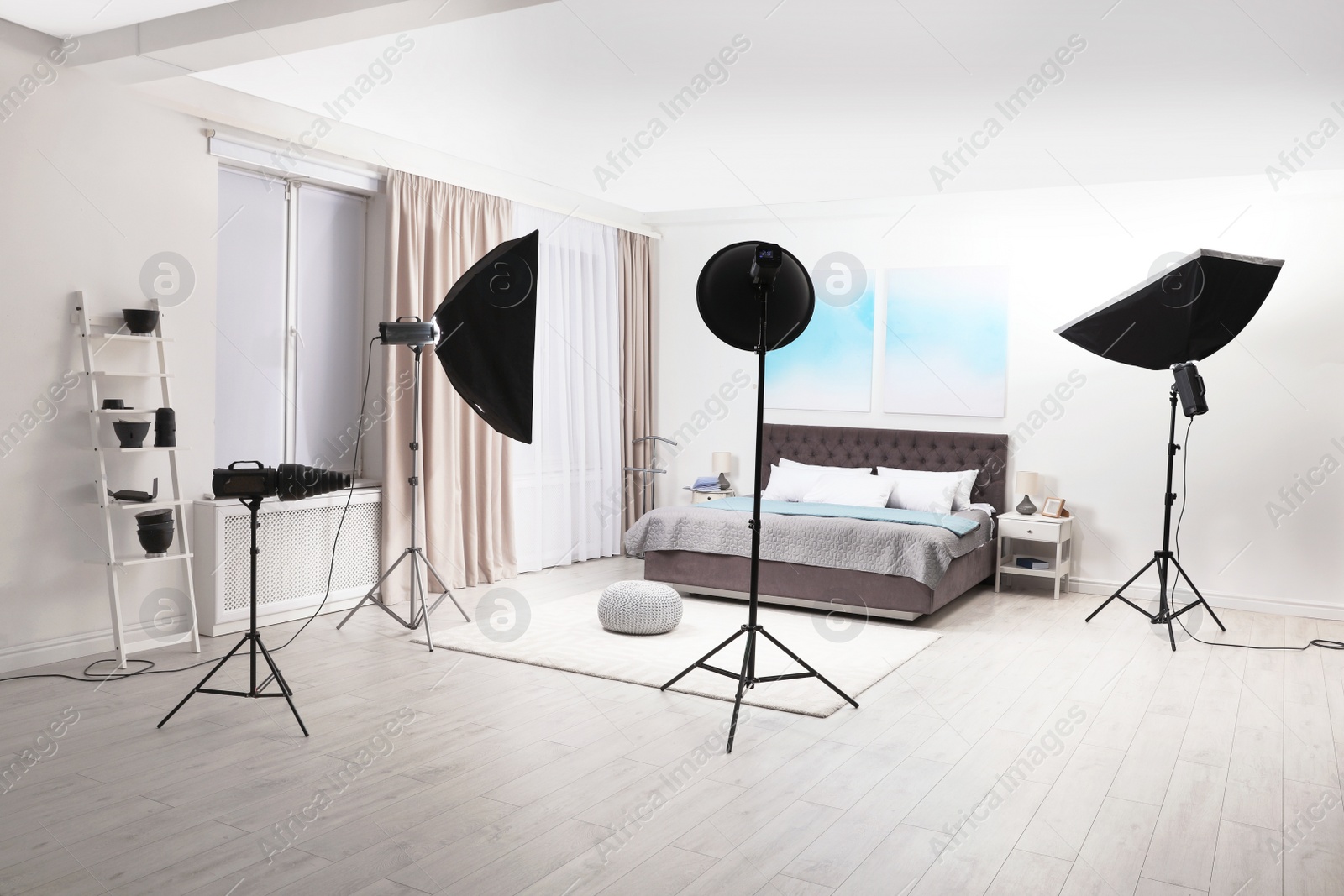 Photo of Professional photo studio equipment prepared for shooting bedroom interior