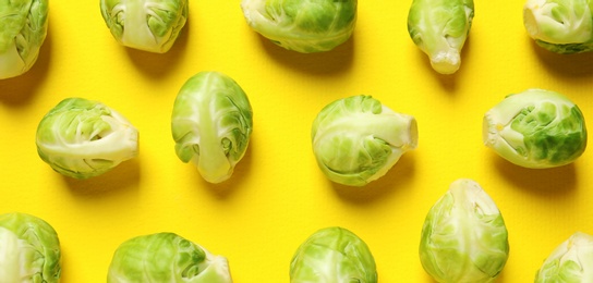 Photo of Fresh Brussels sprouts on color background, flat lay