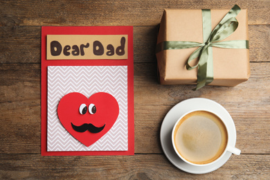 Photo of Flat lay composition with card for Father's day on wooden table