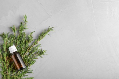 Flat lay composition with fresh rosemary oil on table