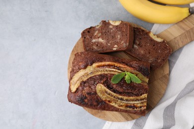 Photo of Delicious banana bread on grey table, top view. Space for text