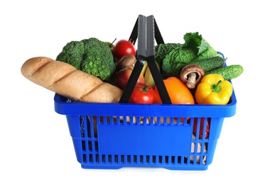 Shopping basket with grocery products on white background