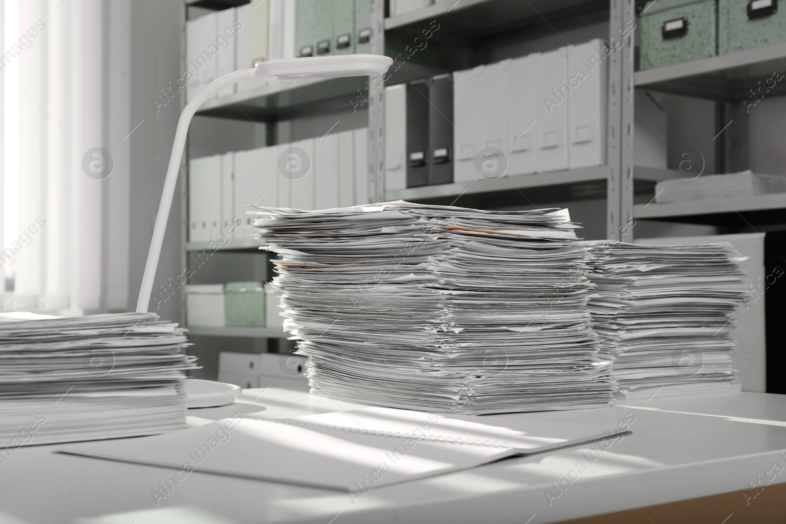 Photo of Stacks of documents on table in office