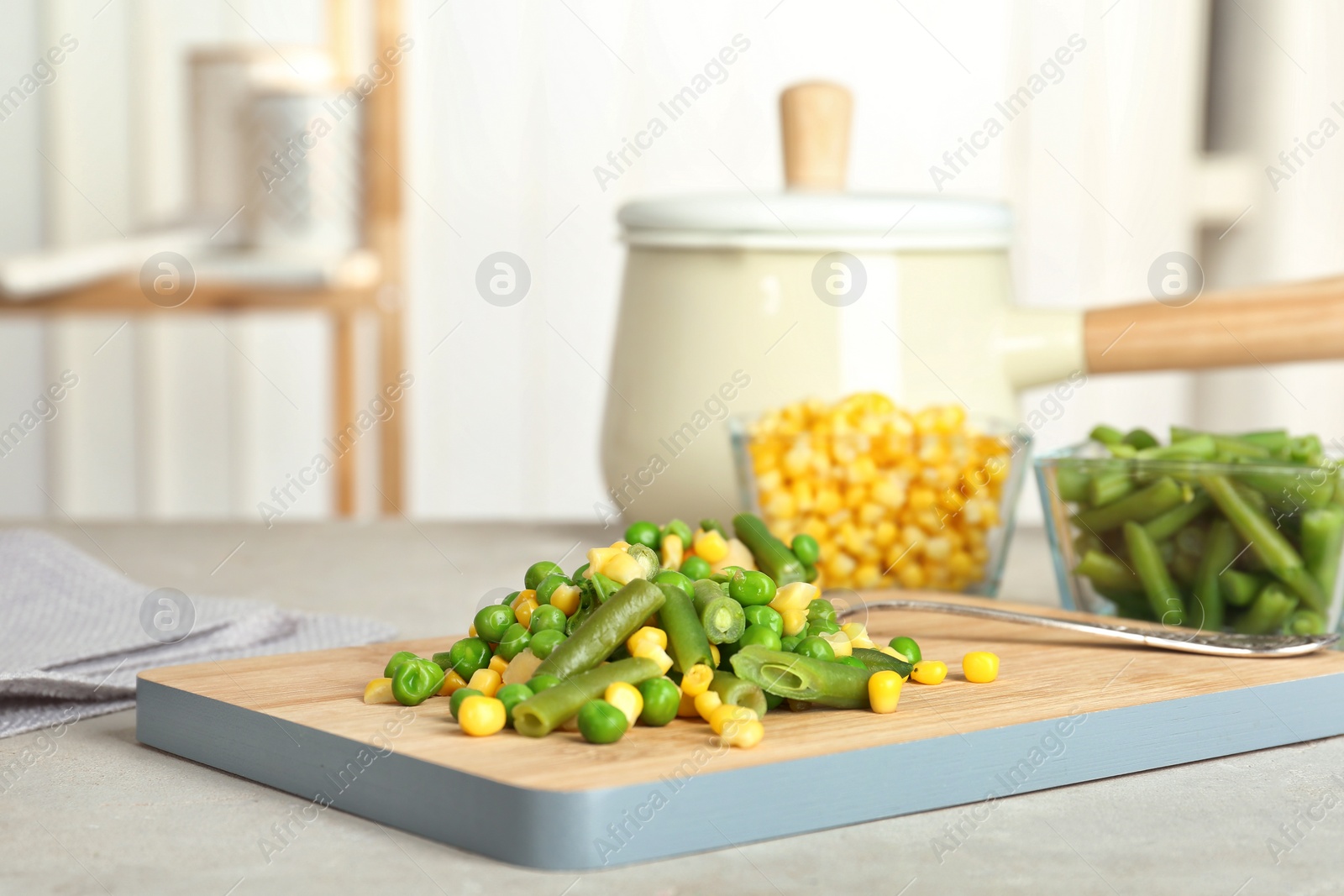 Photo of Board with mix of frozen vegetables on table