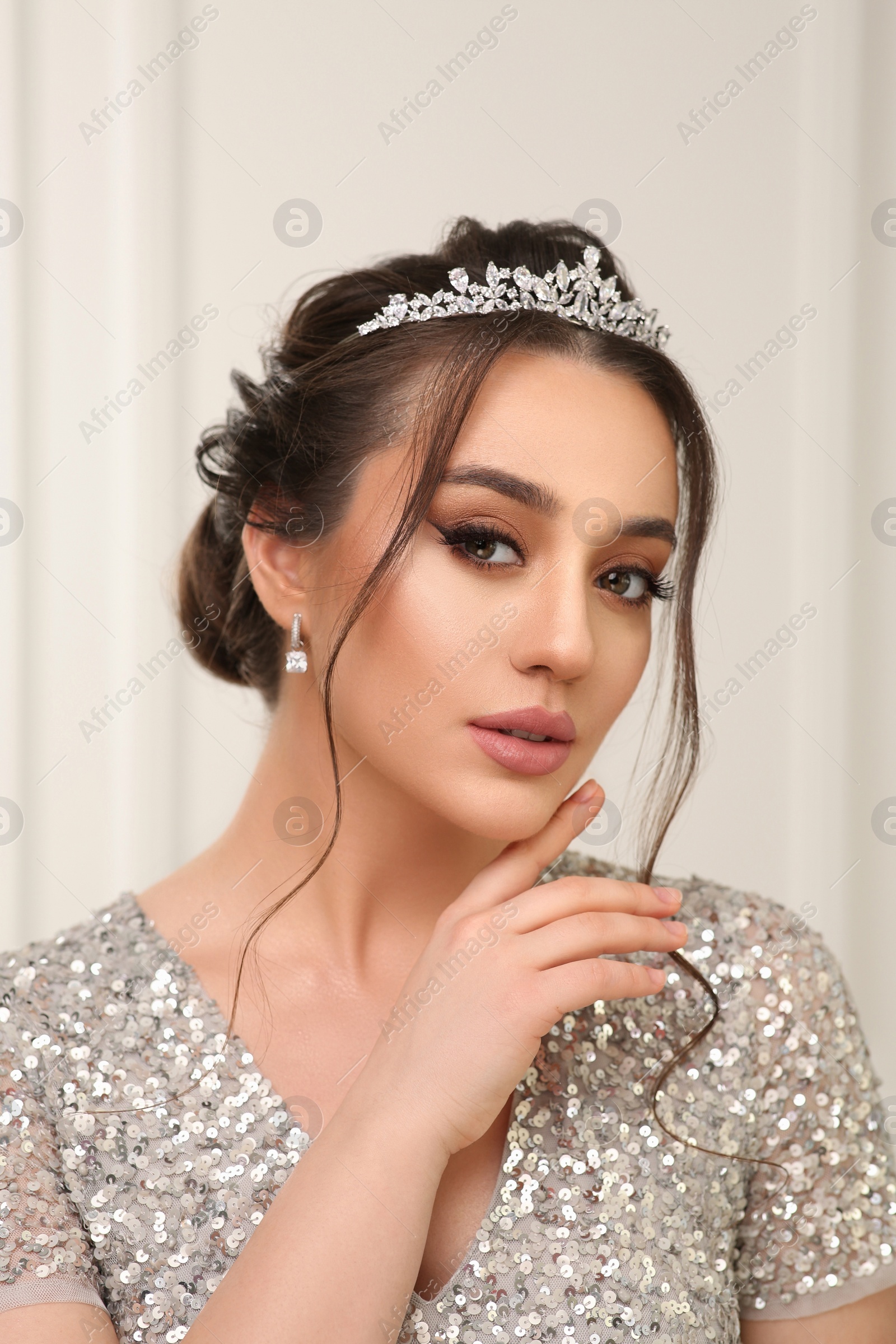 Photo of Beautiful young woman wearing luxurious tiara indoors