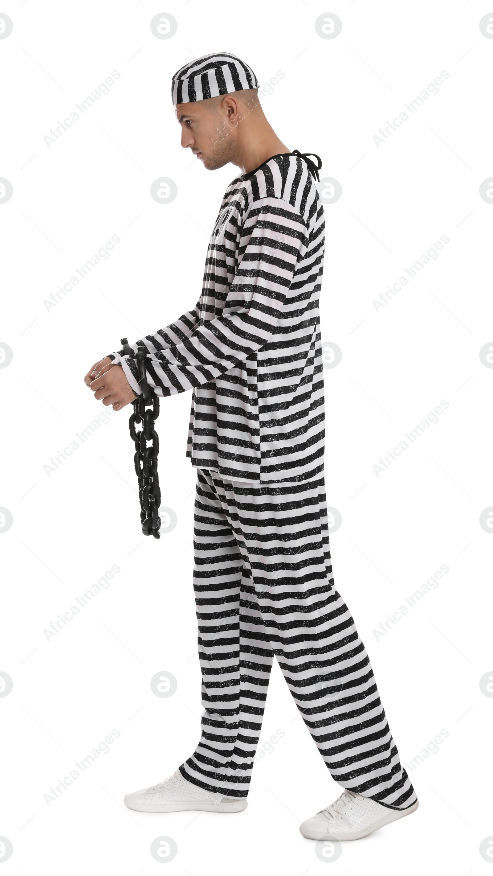 Photo of Prisoner in striped uniform with chained hands on white background
