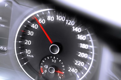 Speedometer on car dashboard, closeup. Motion blur effect