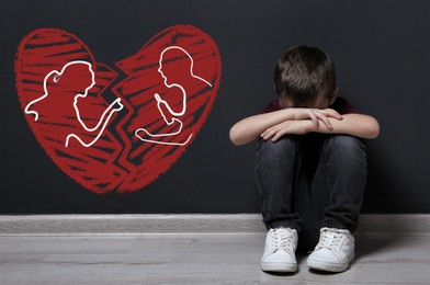 Image of LIttle boy upset because of parents divorce on pink background. Illustration of broken heart and arguing couple