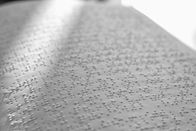 Page of book with Braille text, closeup. Education for blind people