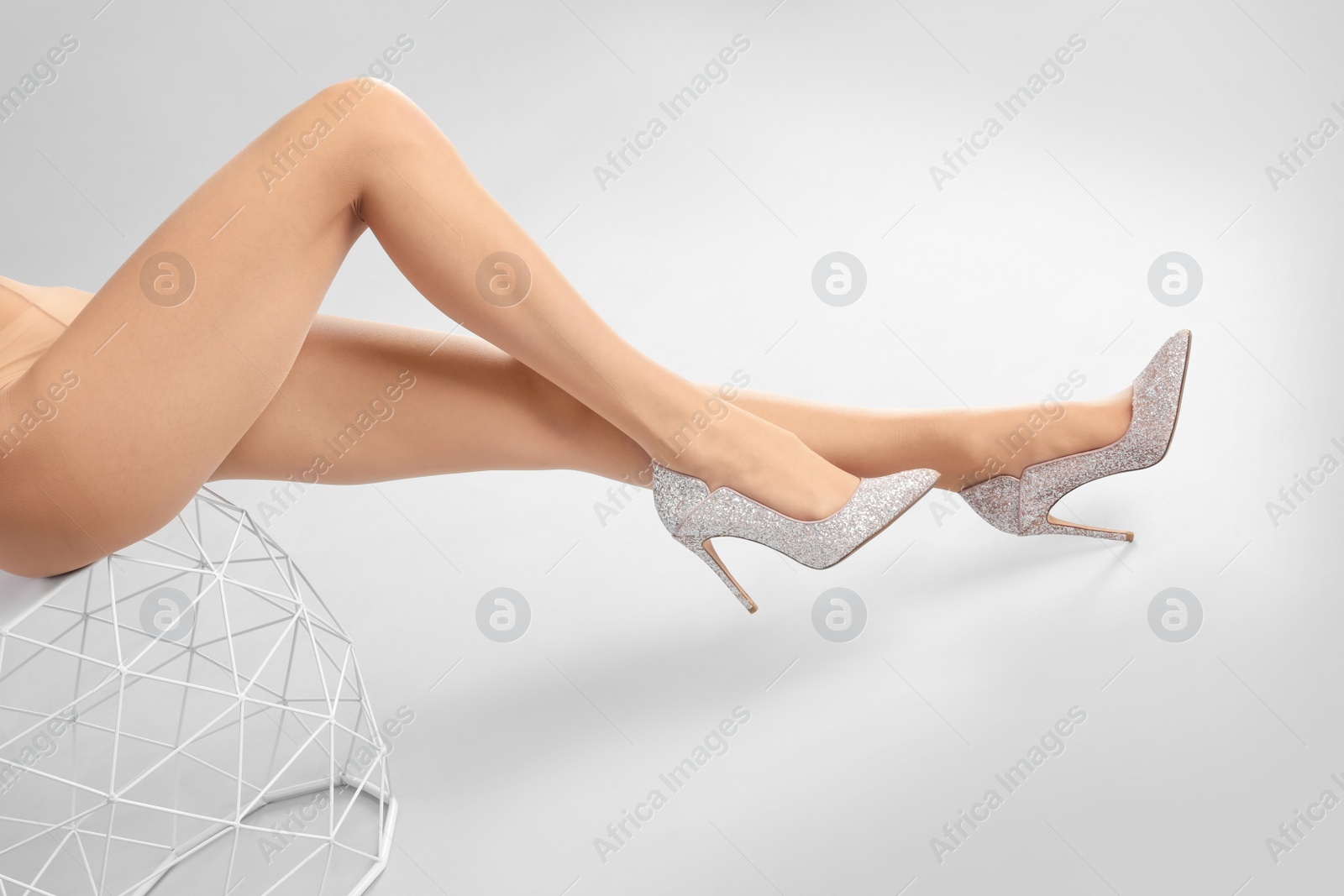 Photo of Woman wearing tights and stylish shoes on light grey background, closeup of legs