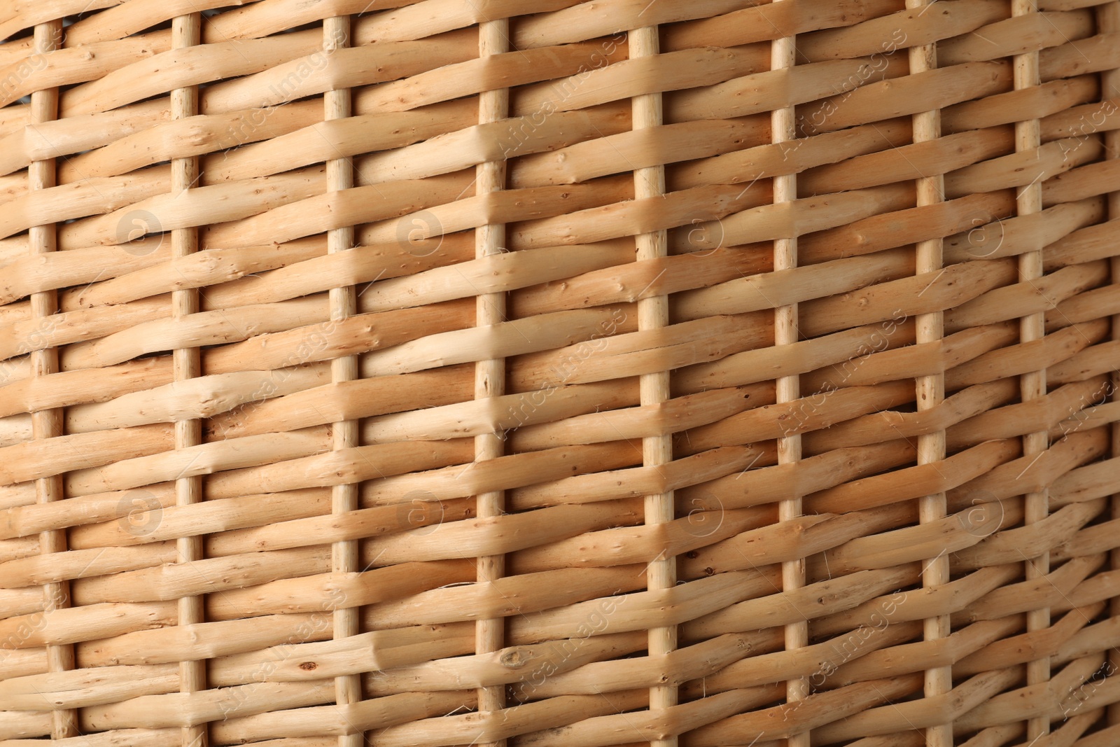 Photo of Handmade wicker basket made of natural material as background, closeup view