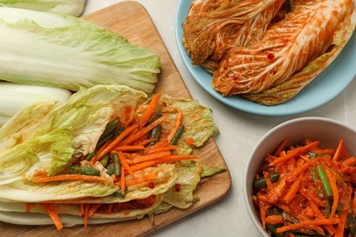 Ingredients for spicy cabbage kimchi on beige marble table, above view