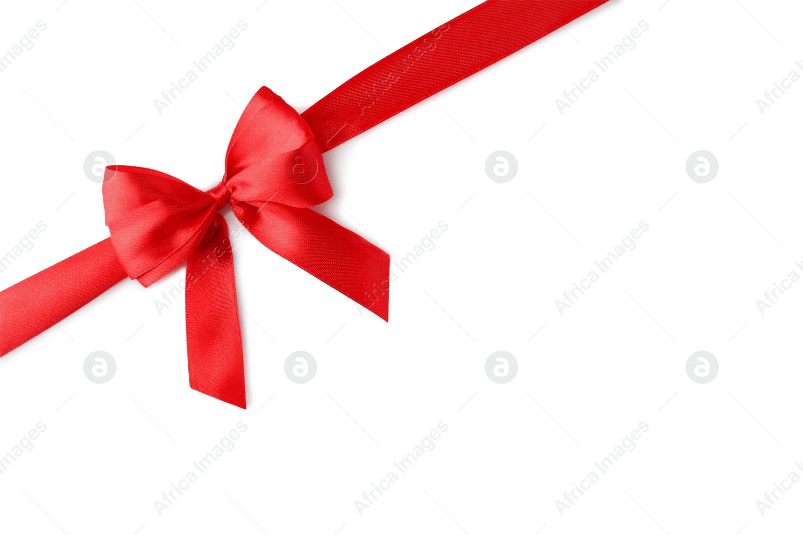 Photo of Red bow and ribbon on white background, top view