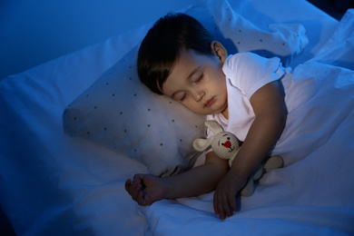 Cute little baby sleeping with toy at home. Bedtime