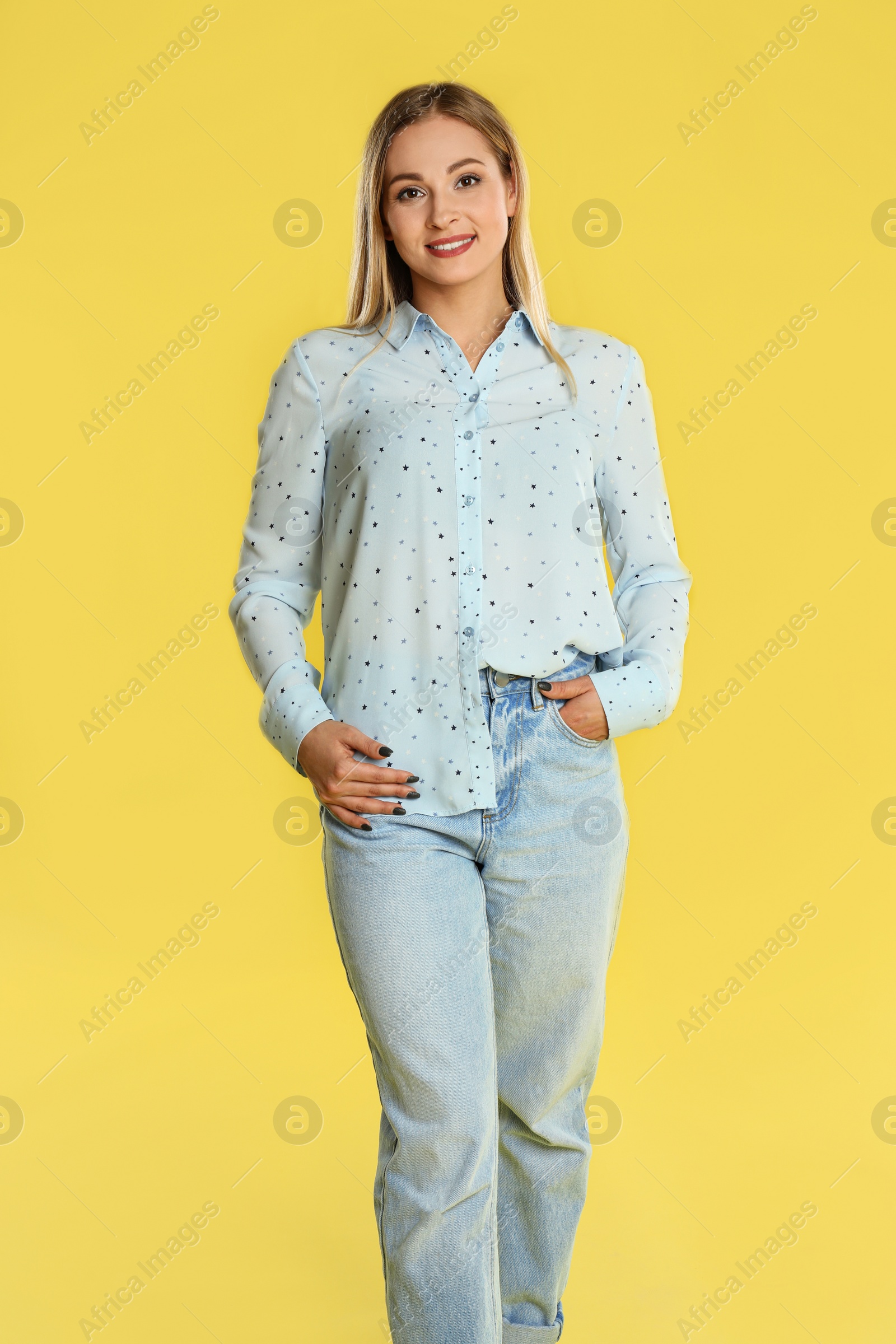 Photo of Beautiful woman in casual outfit on yellow background