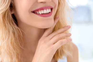 Young woman with beautiful smile indoors. Teeth whitening